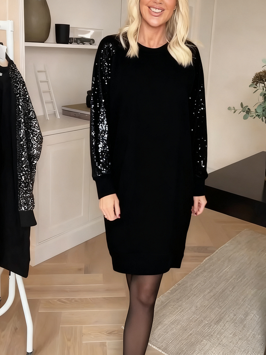 Damesjurk Noor met glanzende paillettenmouwen en ronde hals